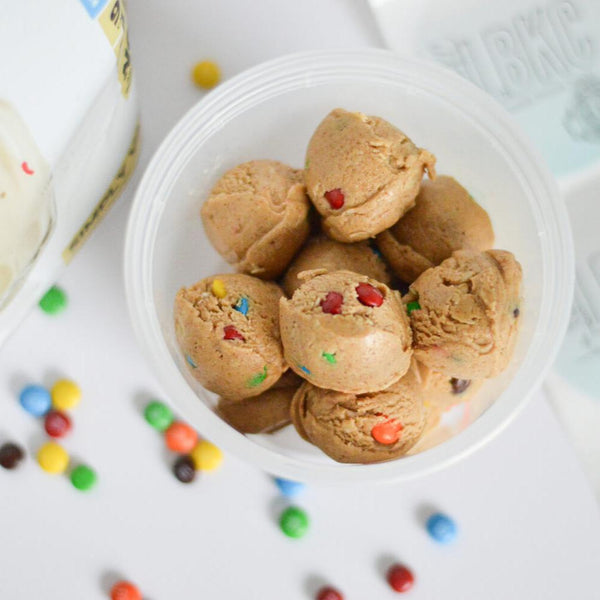 A container full of protein bites made with m&m candies.