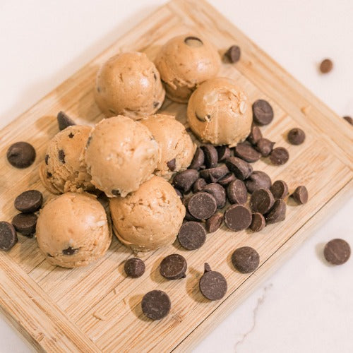 Peanut Butter Chocolate Chip Protein Bites on Wood Cutting Board