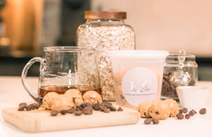 Protein bites on a cutting board surrounded by ingredients