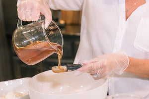 Raw Honey being poured into a measuring spoon